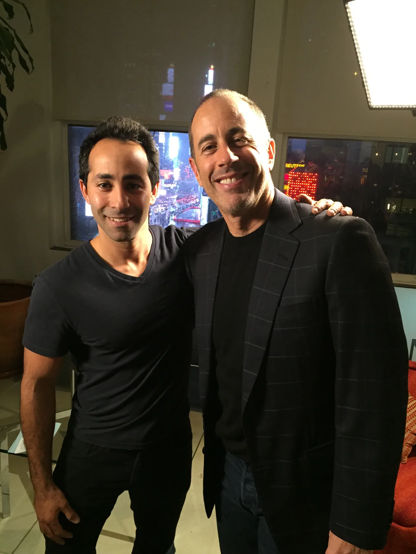 Matthew Legreca photographed with an on-camera guest backstage at an event