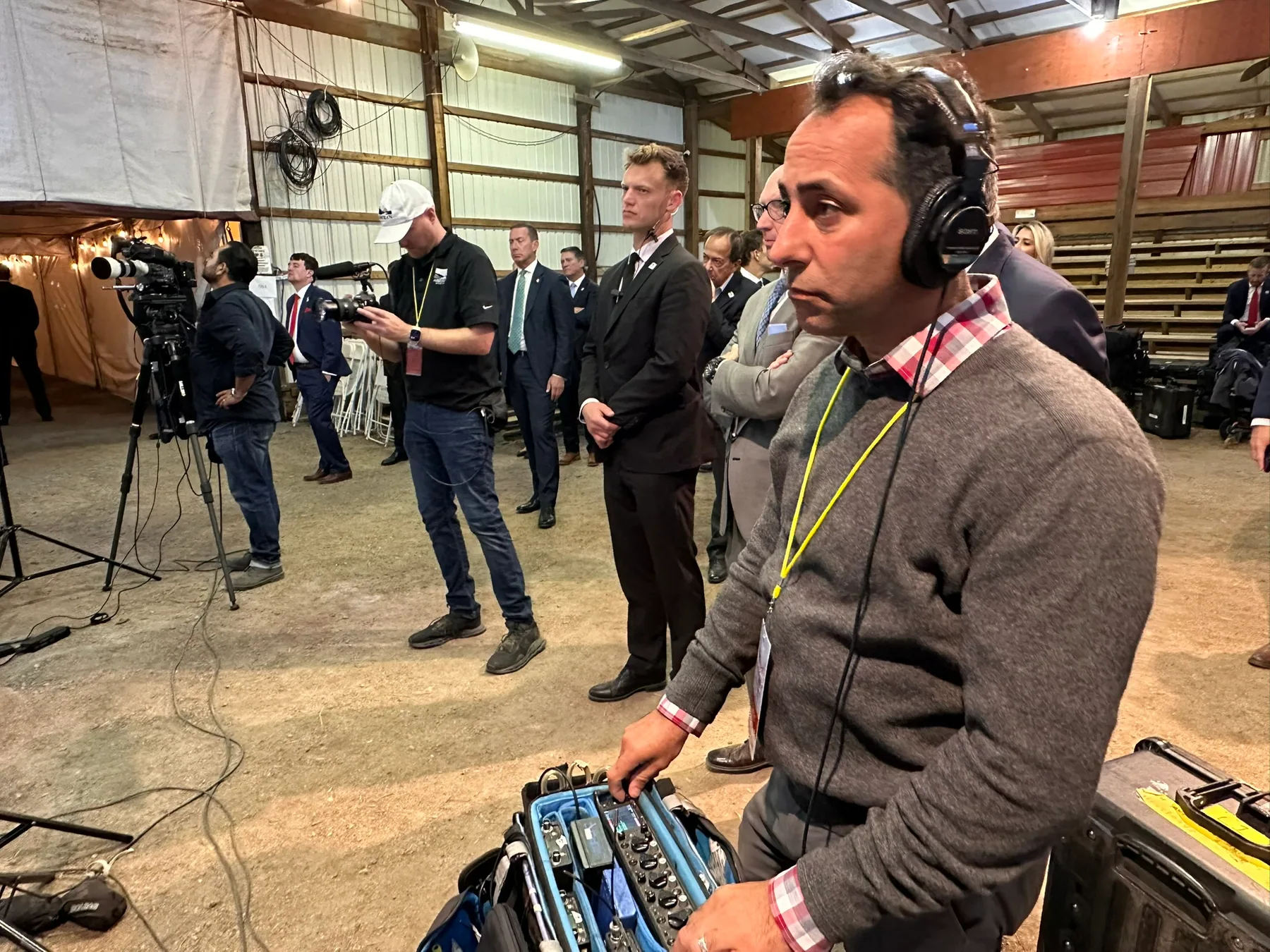 Matthew Legreca wearing headphones beside a horse during a field shoot