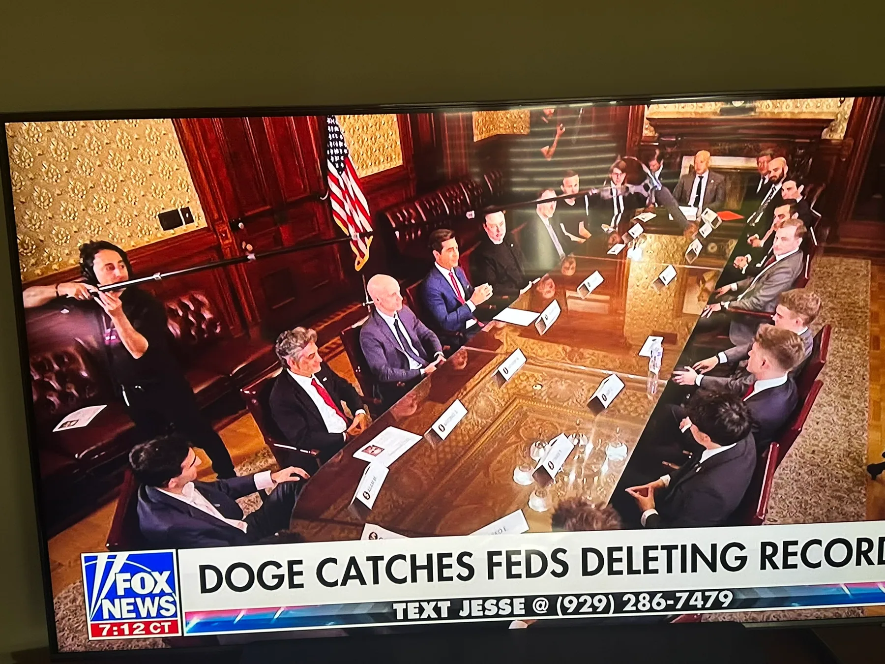 Television monitor showing Matthew Legreca booming audio in a meeting room