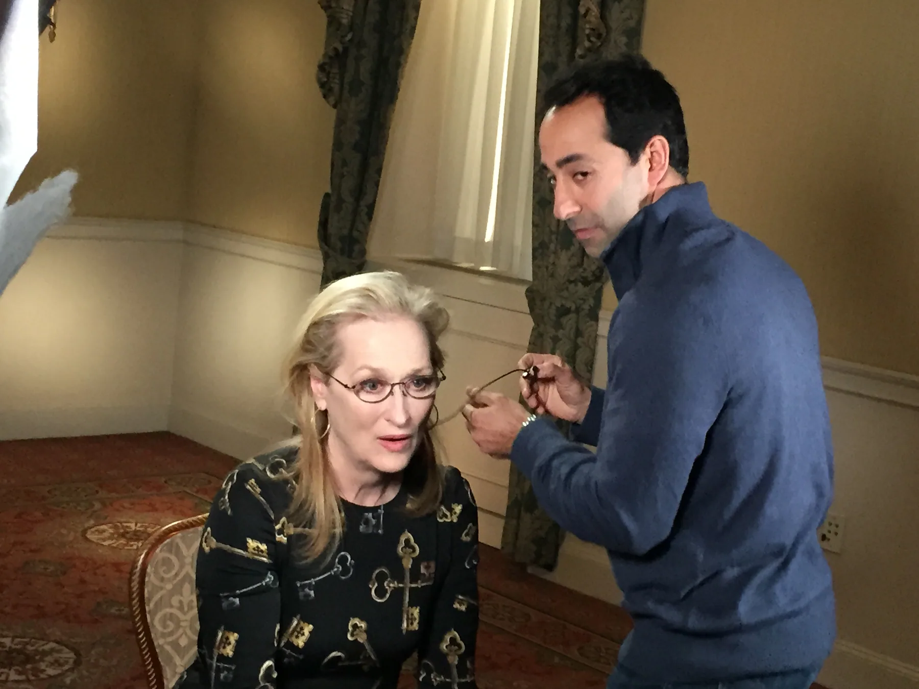 Matthew Legreca fitting a lavalier microphone before a sit-down interview